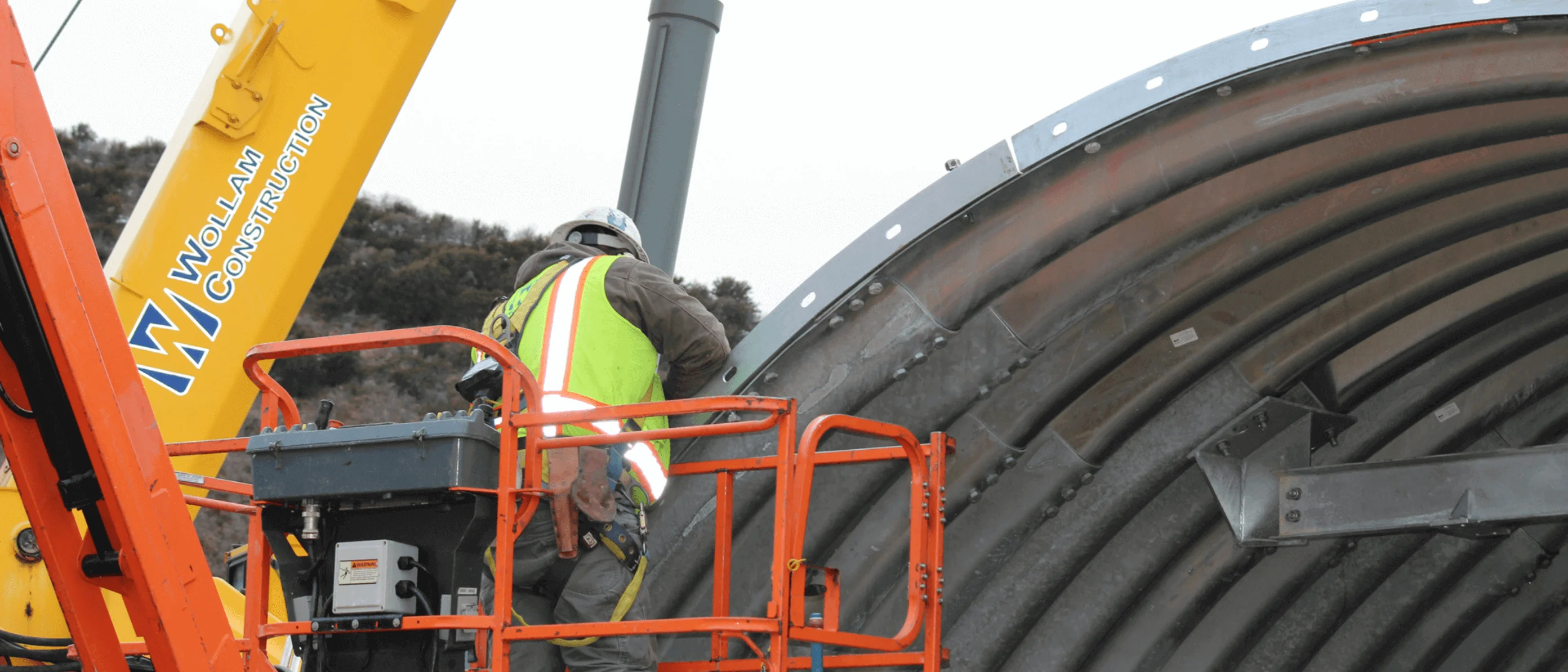 Wollam Construction Employee Working At A Job Site