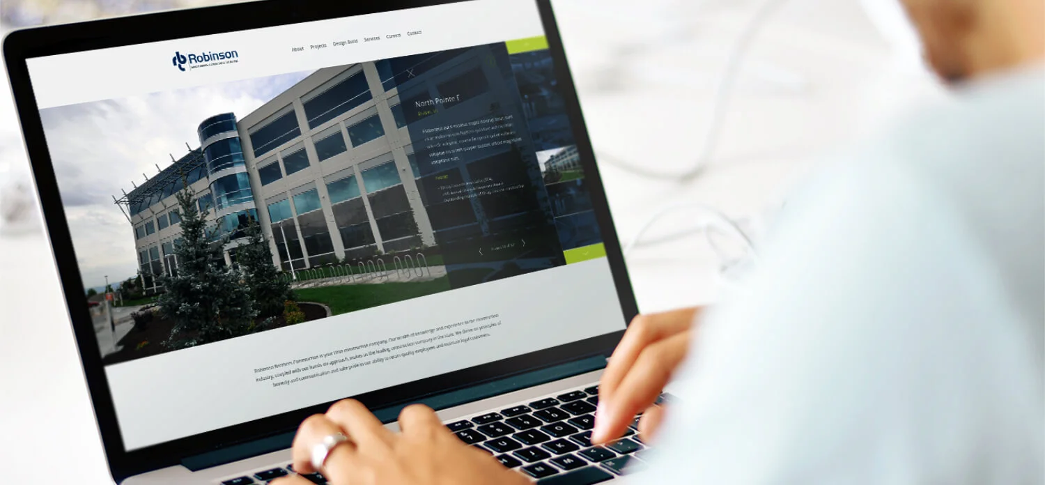 Person Looking At Robinson Brothers Website On Laptop