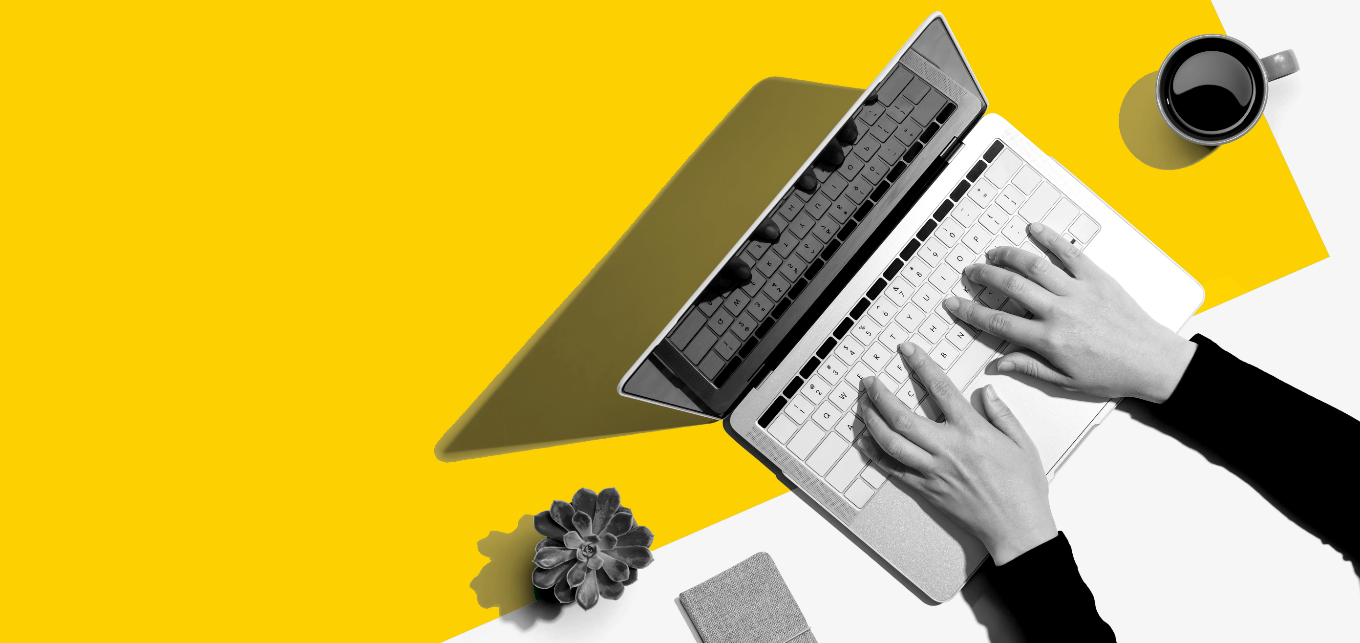 Person using computer with coffee mug nearby