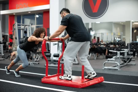 A VASA Personal Trainer Exercising With A Member