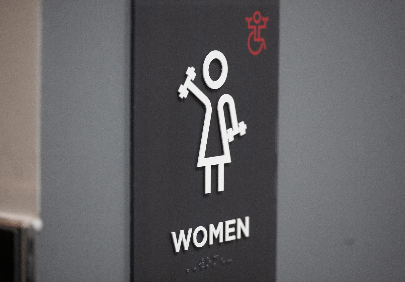VASA Gym Women's Locker Room Sign With Character Lifting Weights