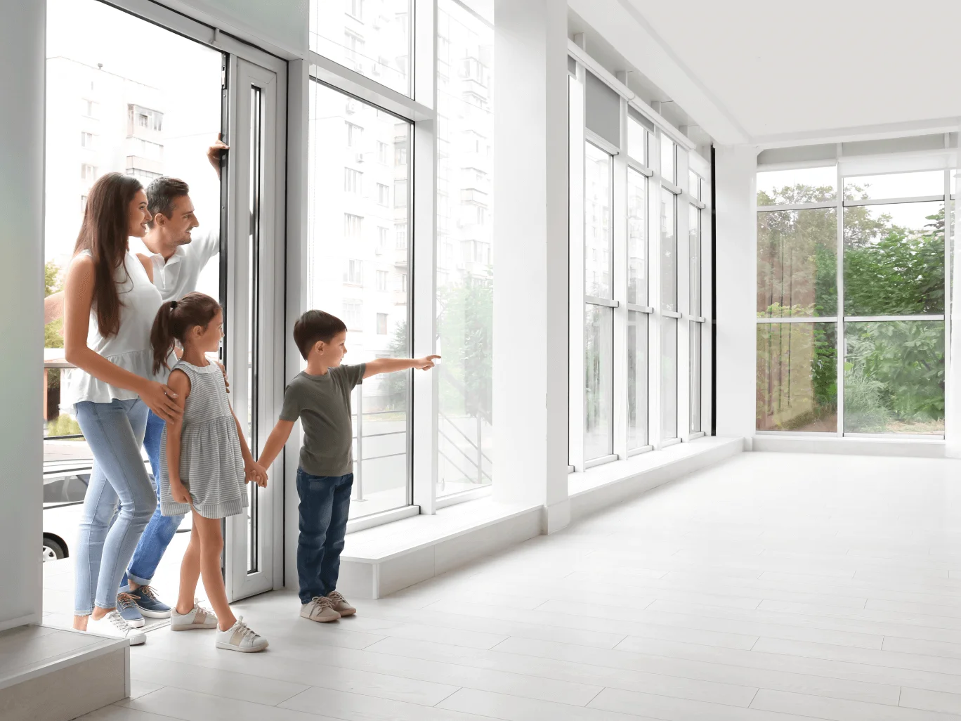 Family Entering New Home With White Interior