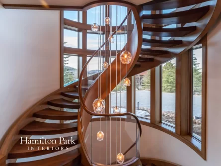 Beautiful Spiral Staircase With Hanging Lights and Hamilton Park Interior Logo