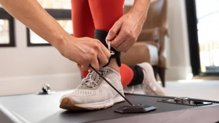 Person At Home Setting Up Sole Fitness Product